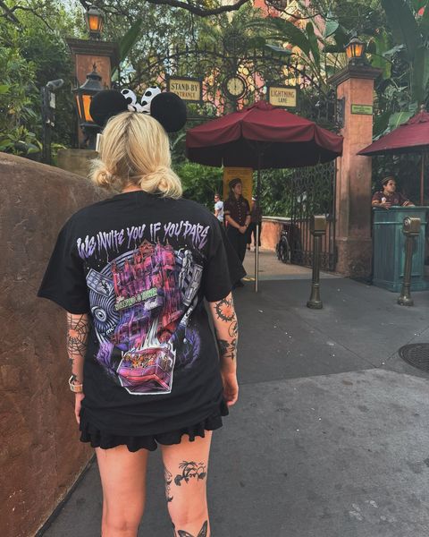 Someone wearing a Mouse House design in a theme park