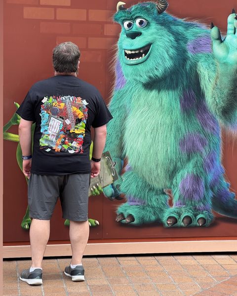 Someone wearing a Mouse House design in a theme park