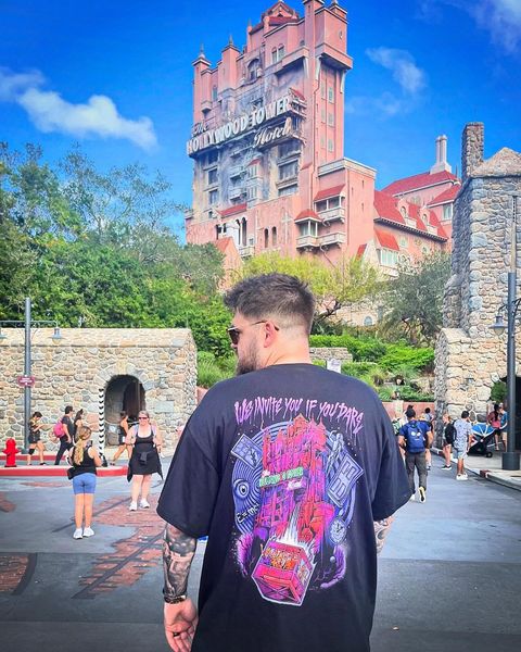 Someone wearing a Mouse House design in a theme park