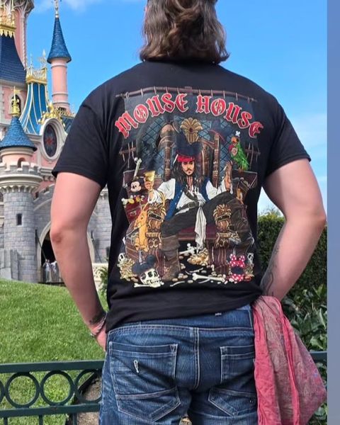Someone wearing a Mouse House design in a theme park