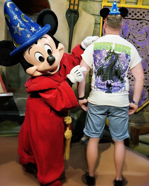Someone wearing a Mouse House design in a theme park