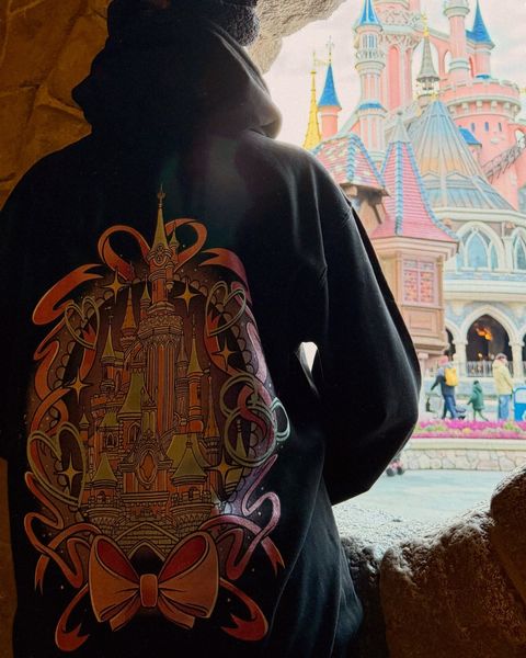 Someone wearing a Mouse House design in a theme park