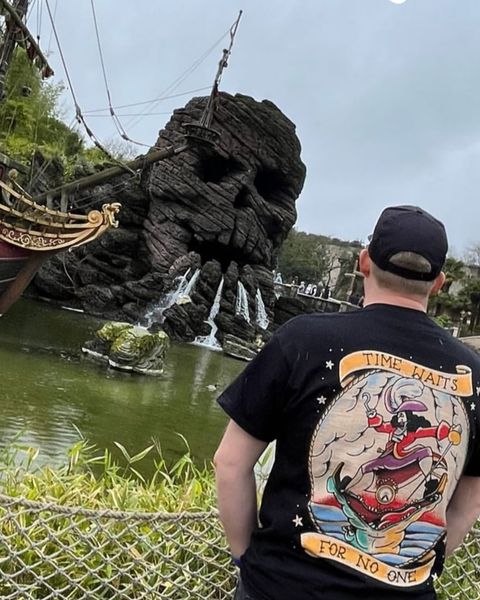 Someone wearing a Mouse House design in a theme park