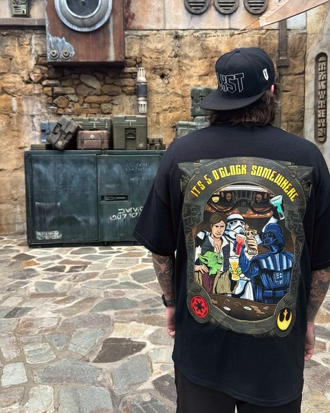Someone wearing a Mouse House design in a theme park